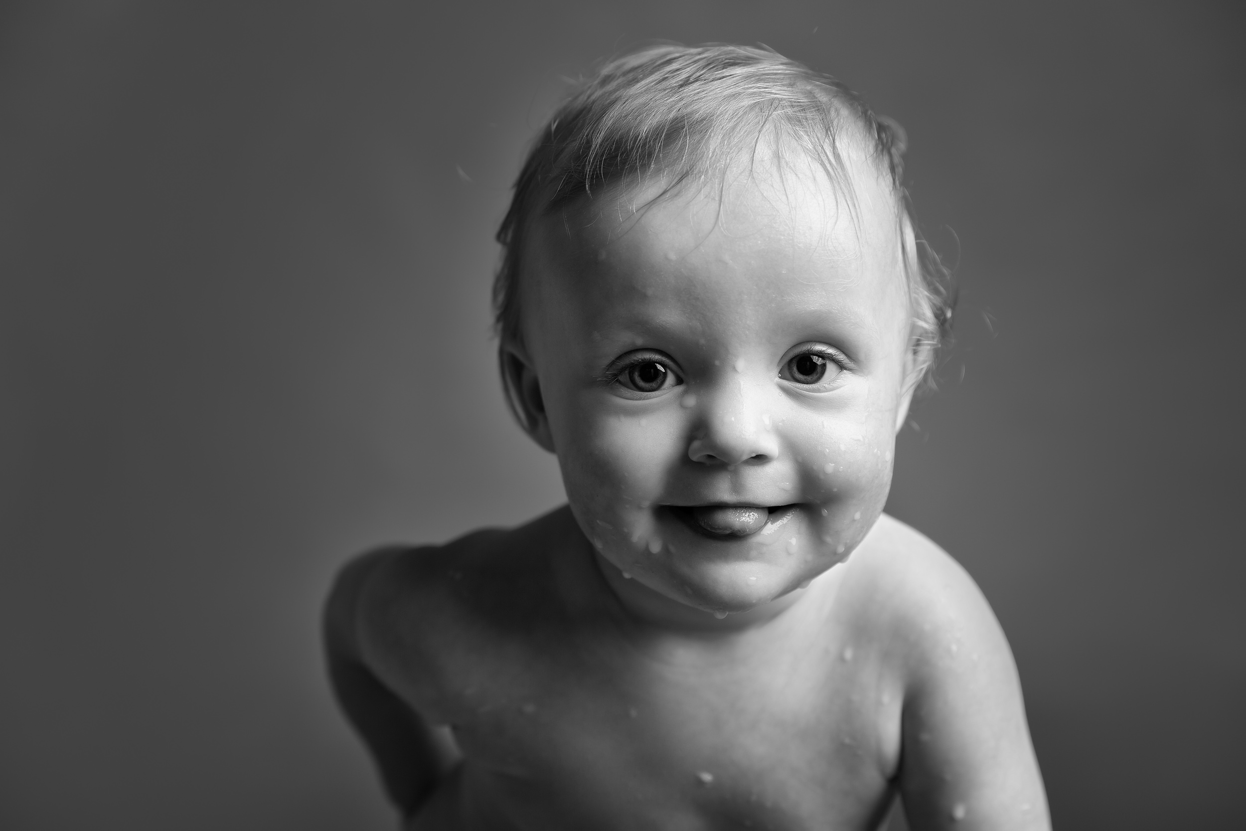1 Year old baby splashing in her milk bath during her photo shoot in Cheshire