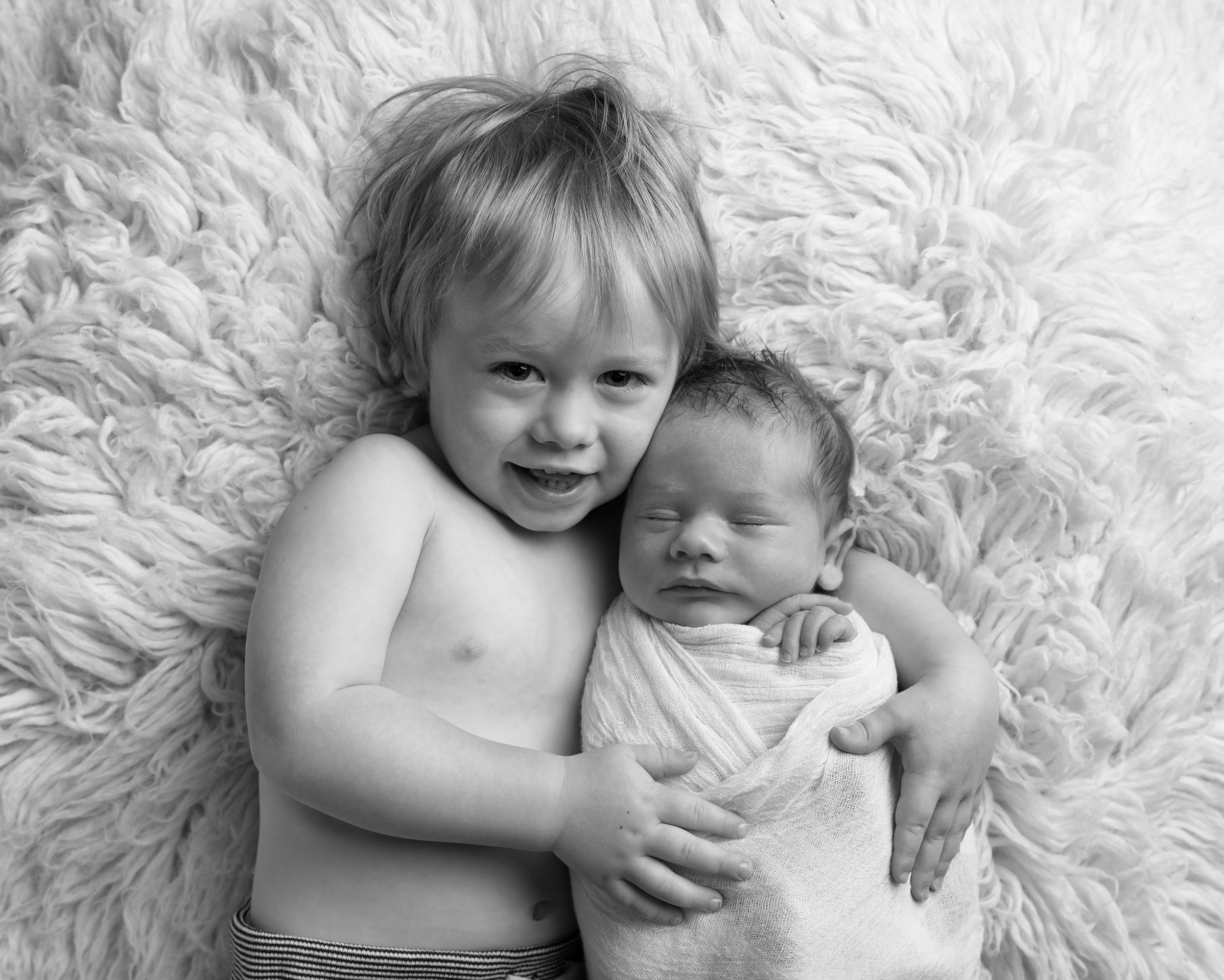 Sibling shot of newborn and his brother by Cheshire newborn photographer in Sandbach