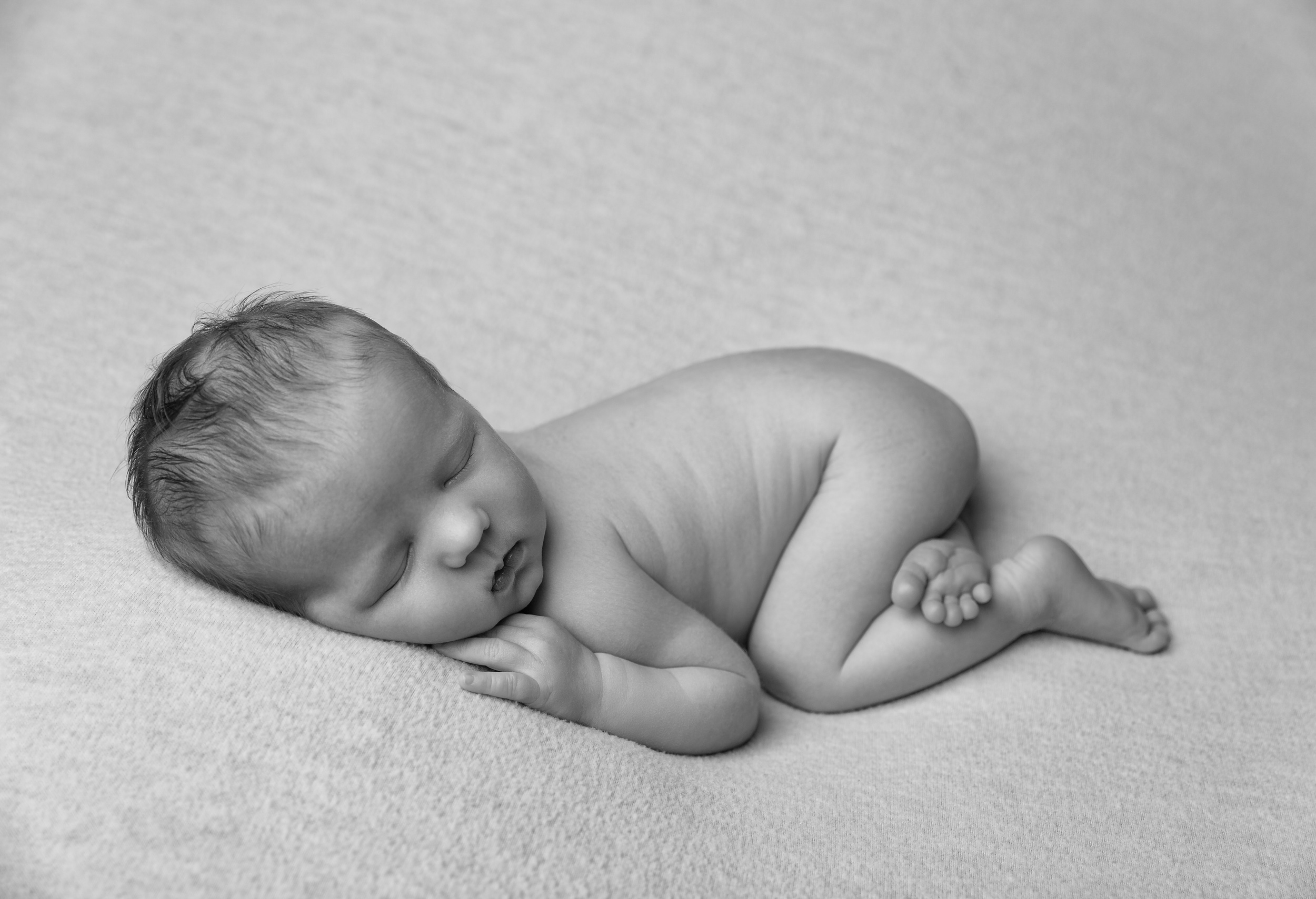 Posed newborn baby by Cheshire newborn photographer in Sandbach