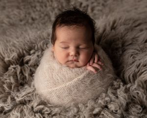 Baby girl in potato sack pose by Cheshire newborn photographer in Sandbach