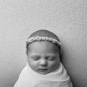 Wrapped newborn baby in black and white from a newborn mini session by Cheshire newborn photographer in Sandbach