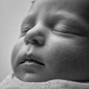 Newborn Baby side profile in black and white from wrapped newborn mini session by Cheshire newborn photographer in Sandbach