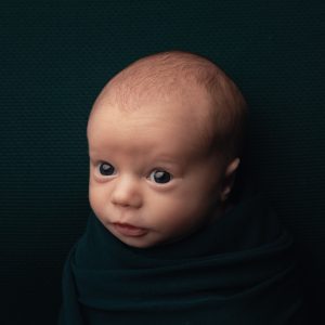 Bright eyed awake newborn baby photo by Cheshire newborn photographer in Sandbach