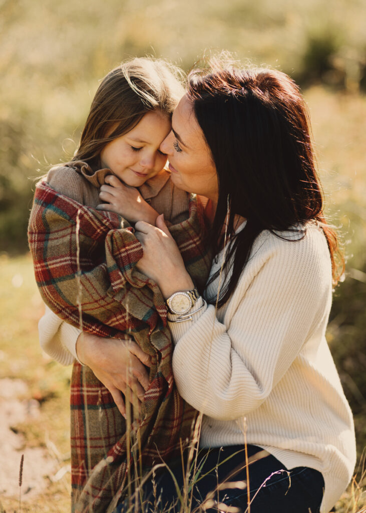 Mother and child share a moment together in a wild location. Beautiful family portrait session outdoors in Nantwich, Cheshire.